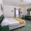 Camera con letto e mobili verdi, vista sul balcone.