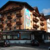 Facciata di un hotel con balconi fioriti.