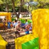 Partita di calcio balilla umano all'aperto con partecipanti sorridenti.
